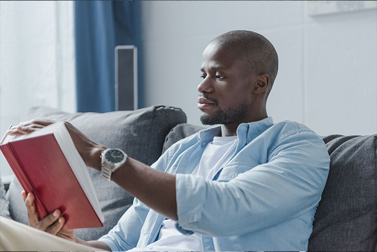 african american man reading to increase his communication skills